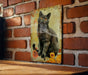 a picture of a cat on a brick wall