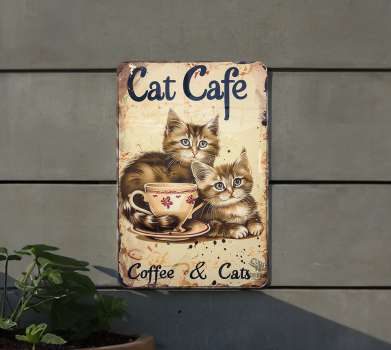 a sign with two cats sitting in a coffee cup