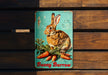 a metal bunny burrow sign on a wooden wall