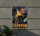 a metal sign that says listening to the universe