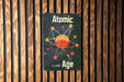 a sign on a wooden wall that says atomic age