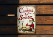 a tin sign that says cookies for santa
