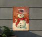 a picture of a snowman with a top hat and scarf
