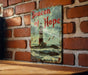 a sign on a brick wall that says beacon of hope