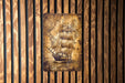 a picture of a ship on a wooden wall