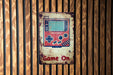 a game on sign on a wooden wall