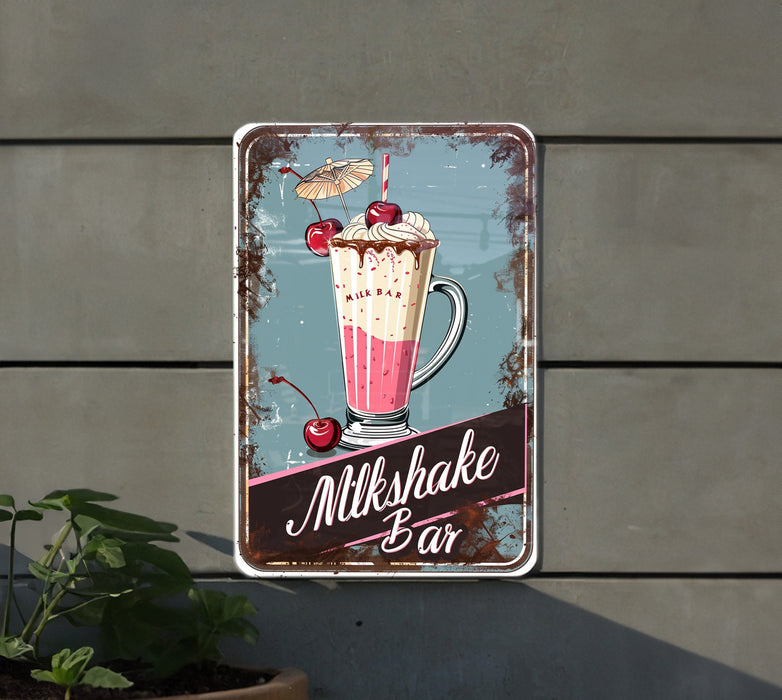 a metal sign that says milkshake bar next to a potted plant