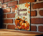 a sign on a brick wall that says autumn harvest