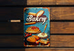 a sign on a wooden bench that says bakery