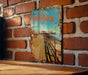 a picture of a sign on a brick wall