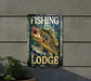 a fishing lodge sign hanging on the side of a building