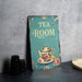 a tea room sign sitting on a table
