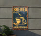 a sign on the side of a building with a cup of coffee being poured into