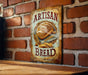 a sign on a brick wall that says artisan bread