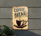 a coffee break sign hanging on a wall