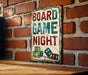 a sign on a brick wall that says board game night