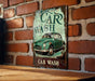 a car wash sign on a brick wall
