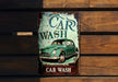 a car wash sign hanging on a wooden wall