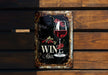 a metal sign with a glass of wine on it