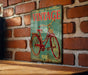 a vintage bicycle sign on a brick wall