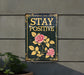 a sign that says stay positive on a wall