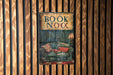 a book is hanging on a wooden wall