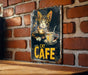 a picture of a cat on a sign on a brick wall