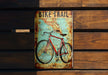 a bike trail sign on a wooden bench