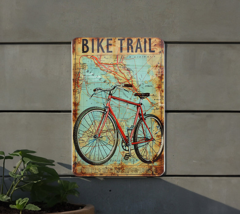 a bike trail sign mounted to the side of a building