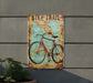 a bike trail sign mounted to the side of a building