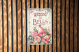 a wedding bells sign hanging on a wooden wall