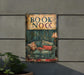 a sign that says book nook on the side of a building