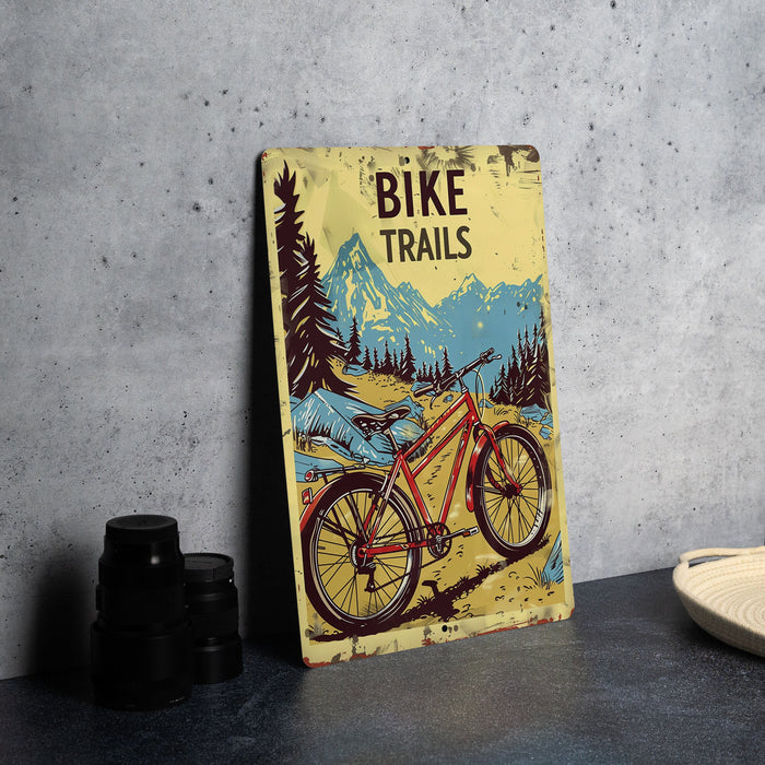 a bicycle trail sign sitting on a table next to a plate