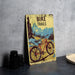 a bicycle trail sign sitting on a table next to a plate