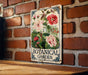 a picture of a botanical garden hanging on a brick wall