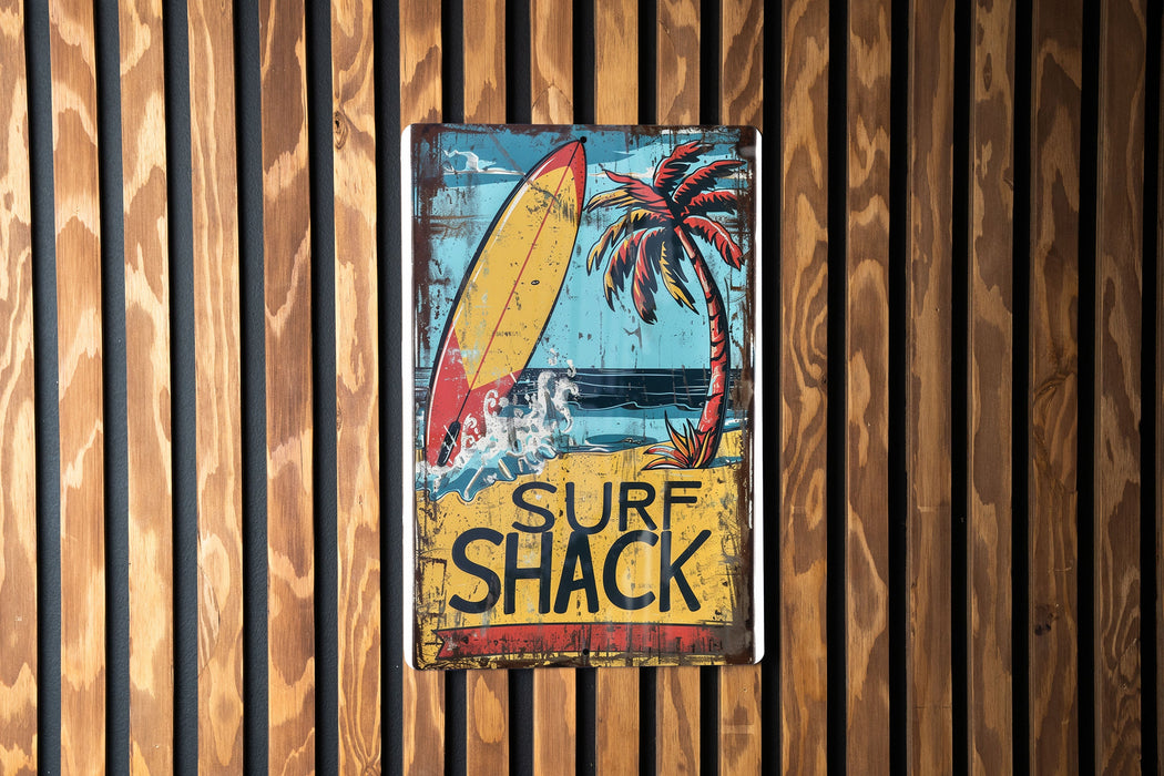 a surf shack sign hanging on a wooden wall