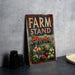 a sign that says farm stand next to a bowl of fruit