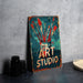 a sign that says art studio with paint brushes in a jar