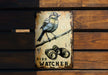 a bird sitting on top of a wooden sign