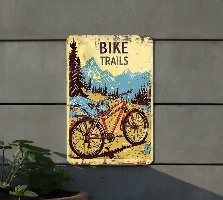 a bicycle trail sign hanging on the side of a building