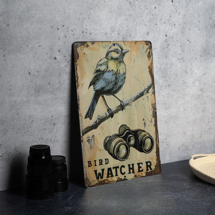 a bird sitting on top of a wooden sign