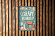 a book about craft is hanging on a wooden wall