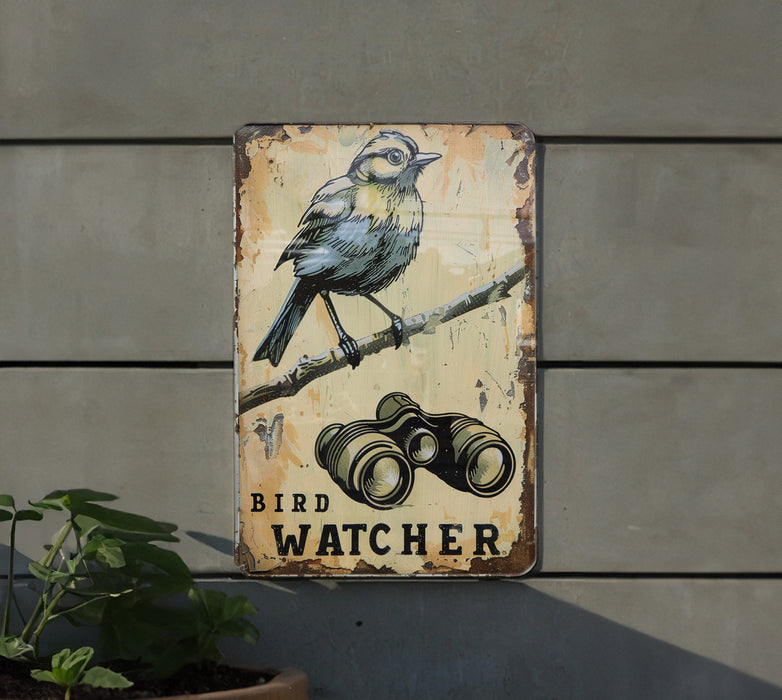 a bird sitting on top of a sign next to a plant