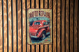 a red car sitting on top of a wooden wall