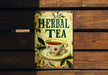 a tin sign with a cup of tea on it