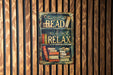 a sign that reads read and relax on a wooden wall