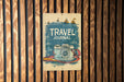 a sign on a wooden wall that says travel journal