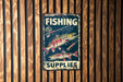 a sign on a wooden wall that says fishing supplies