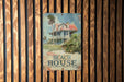 a beach house sign on a wooden wall