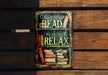 a sign that reads read relax on a bench